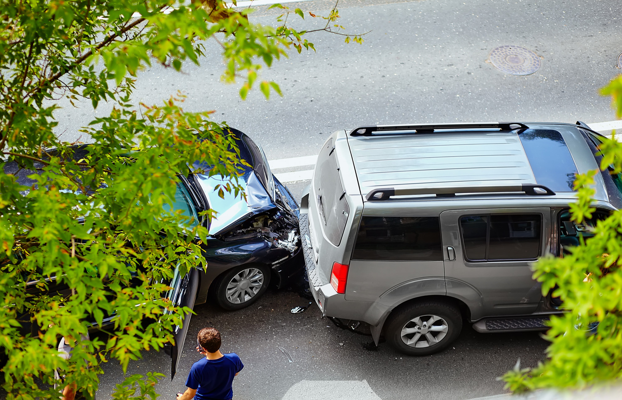 Two cars are seen crashed on a road in Oxford, Alabama. We see an aerial view of the crash and a pedestrian nearby.